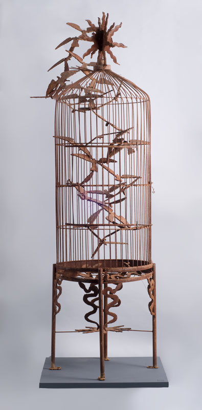 Harold Rittenberry's sculpture "Escape," a large welded-metal bird cage with birds spiraling inside it and around the top, outside the cage