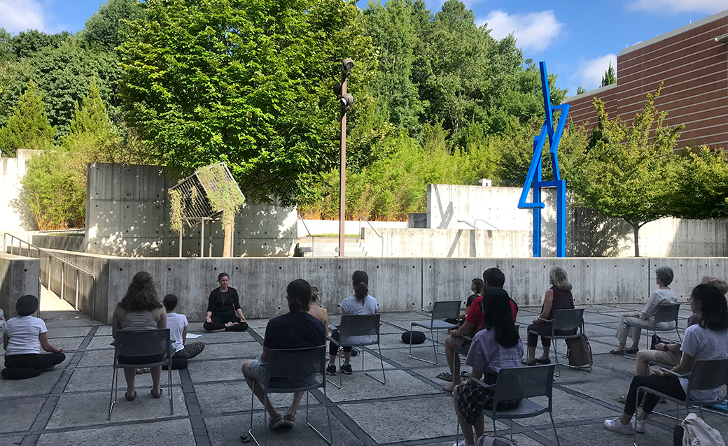 people seated in the sculpture garden for Morning Mindfulness