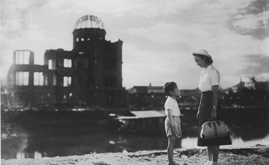 a still from the 1952 film "Children of Hiroshima," with a young woman on the right talking to a small boy whom she faces