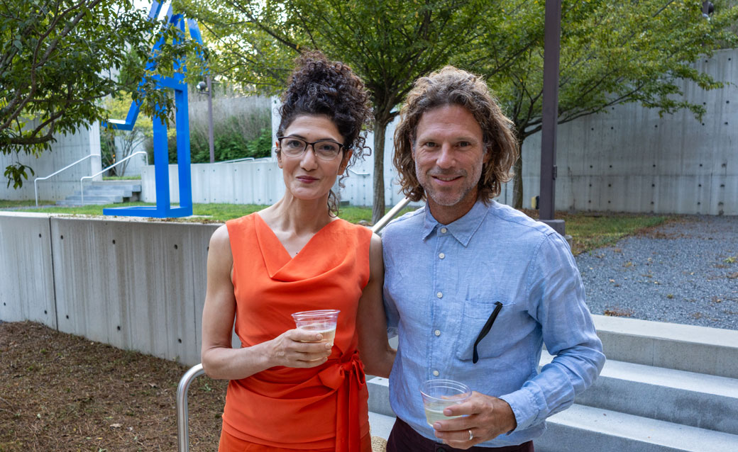 a man and a woman in the sculpture garden at a 90 Carlton reception