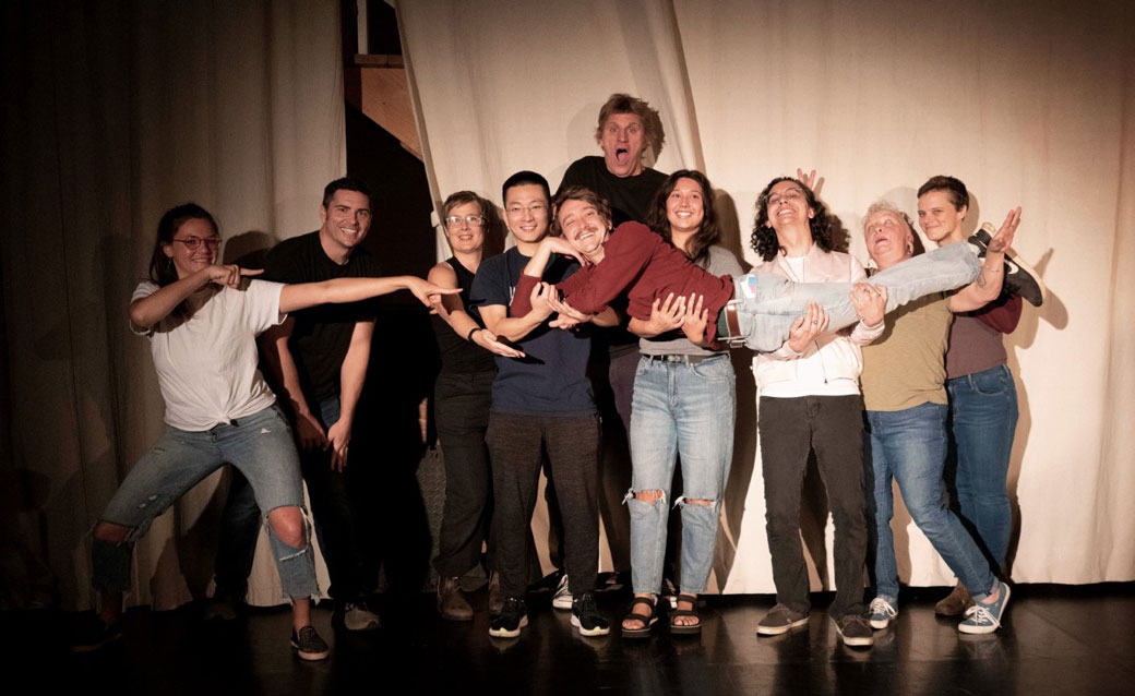 a group of people in a Flying Squid improv comedy class, on stage