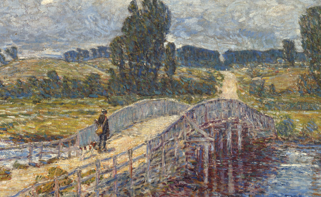 A detail of Childe Hassam's American impressionist painting of a sun-dappled bridge crossing a small river in Old Lyme, Connecticut. A man walks across the bridge, and large trees appear in the background.